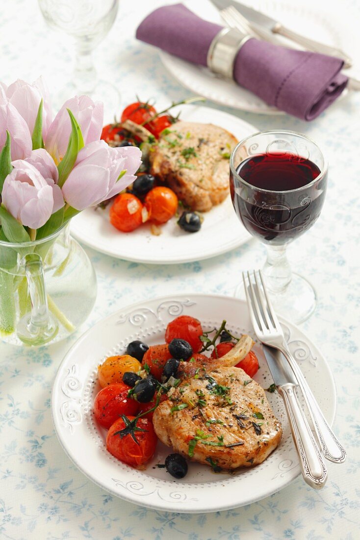 Pork chops with black olives and cherry tomatoes