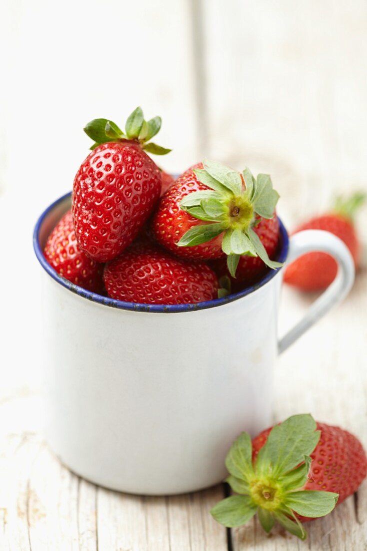 Strawberries in an enamel cup