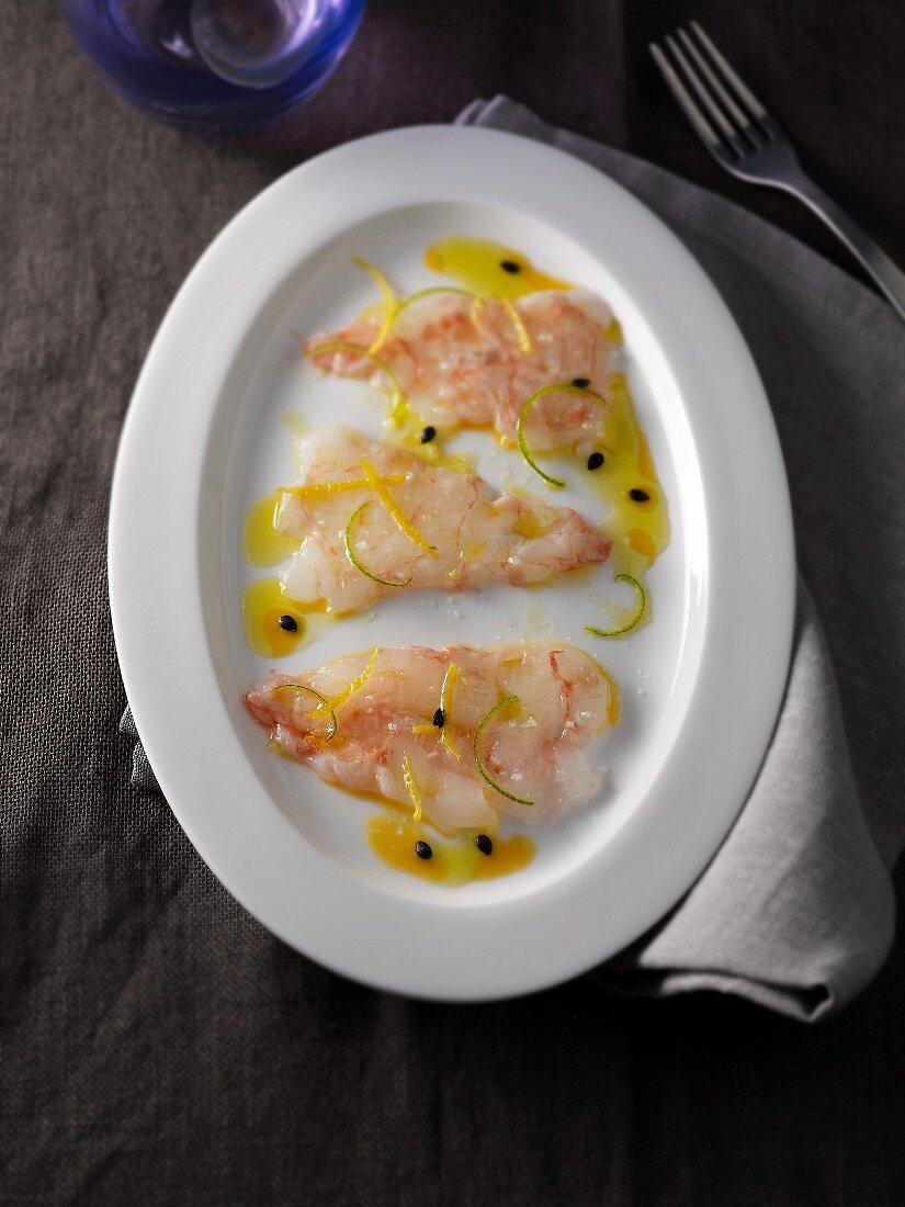 Carpaccio of scampi with passion fruit sauce