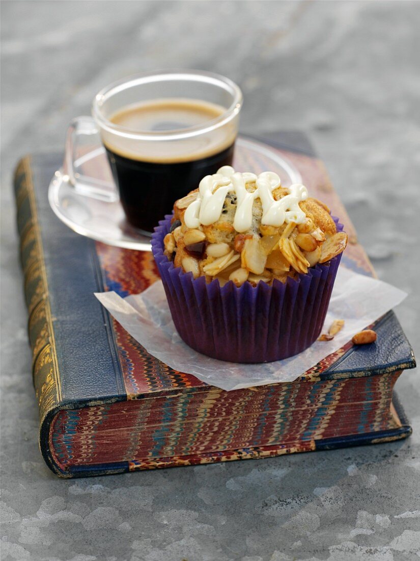 A florentine cupcake with a cup of coffee