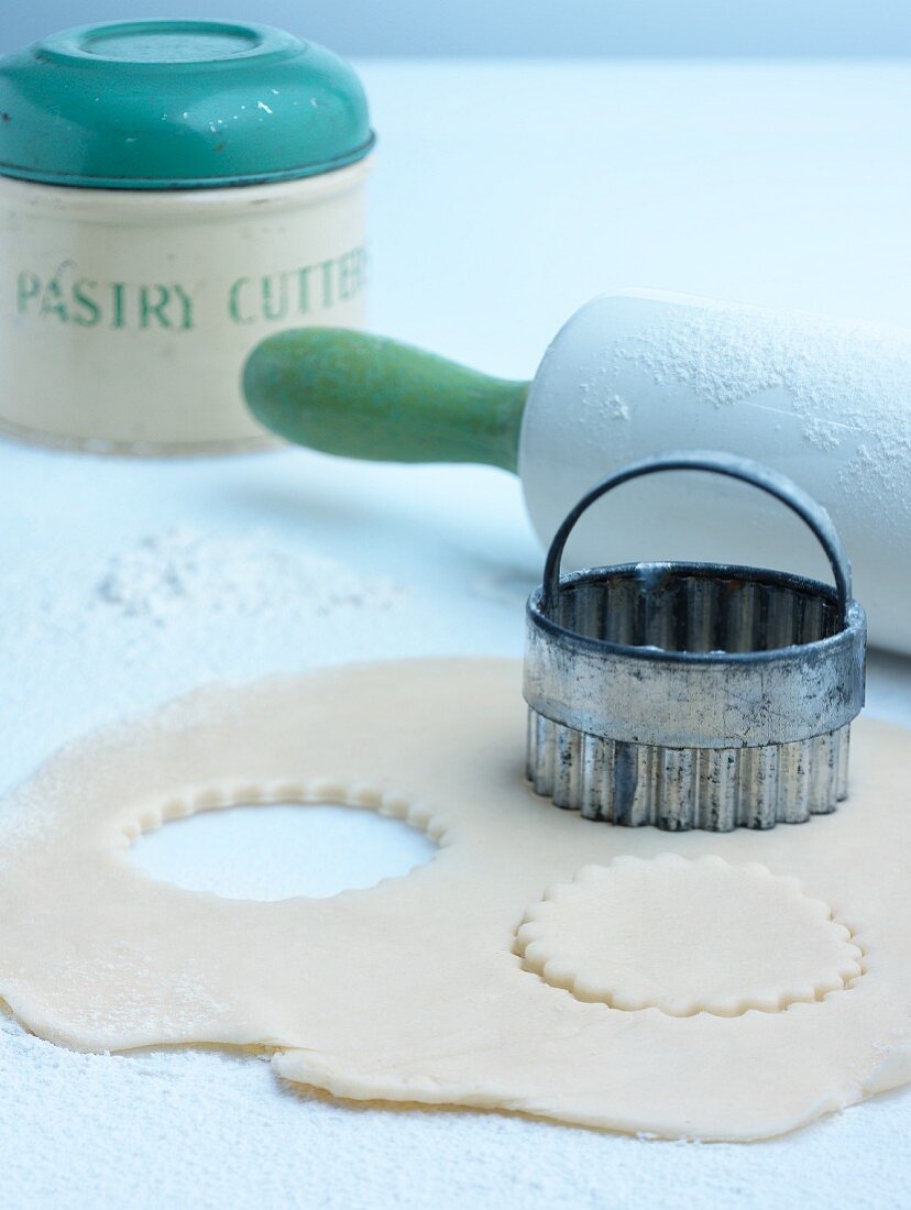 Biscuit dough, a cutter and a rolling pin
