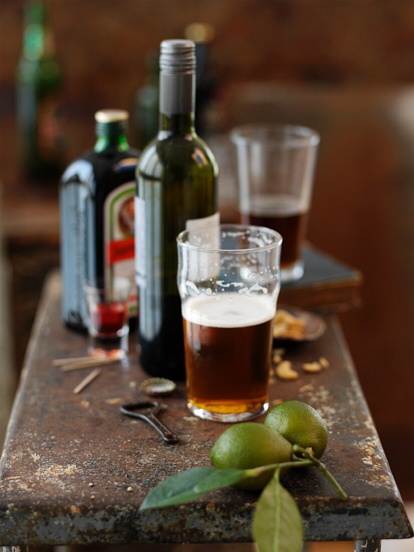 Spirits, drinks and a glass of beer on a rusty bar counter