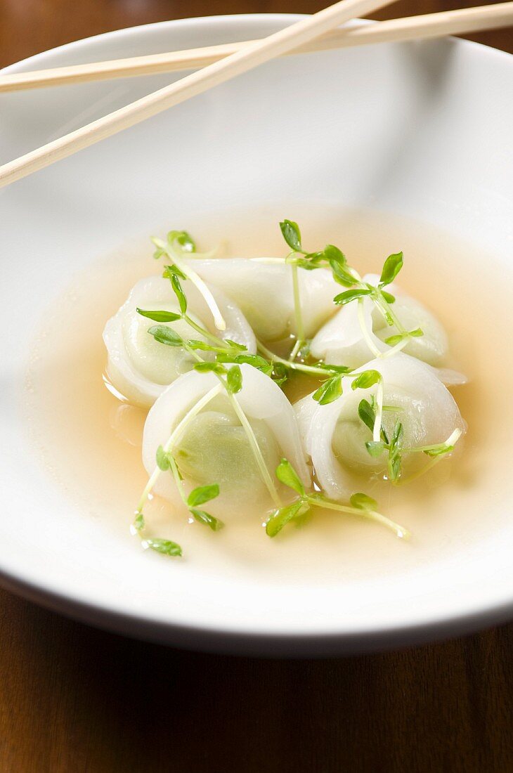 Edamame Dumplings in a Bowl of Broth with Chopsticks