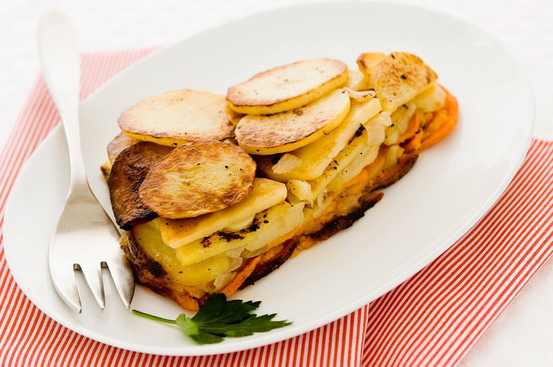 A Piece of Sweet Potato and White Potato Pie on a White Plate