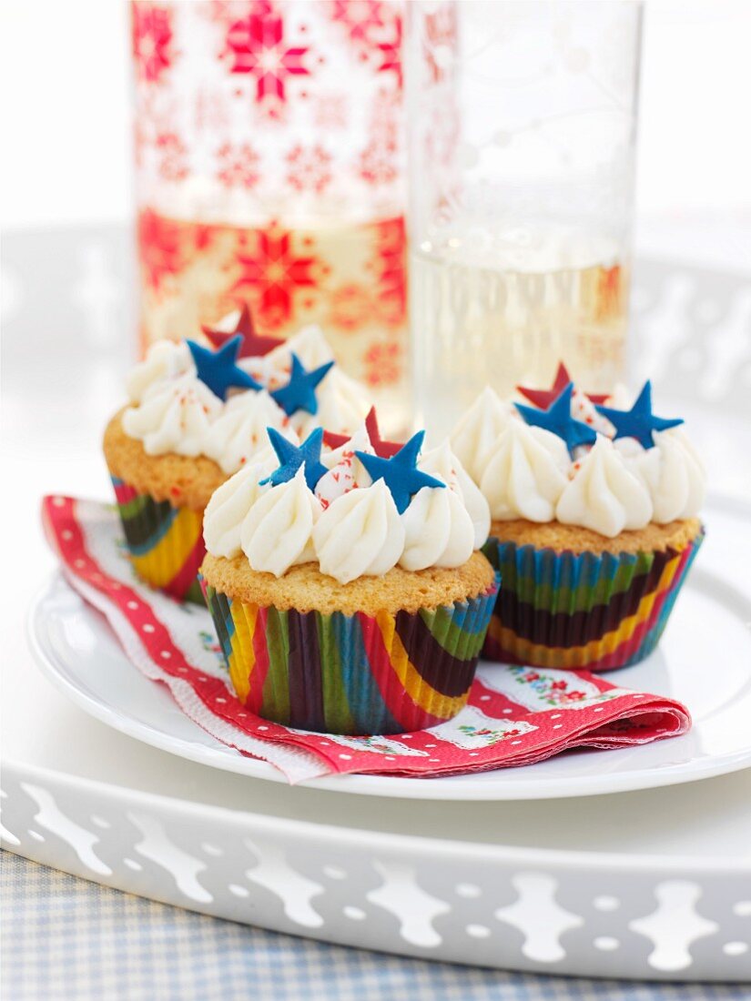 Cupcakes decorated with whipped cream and blue stars