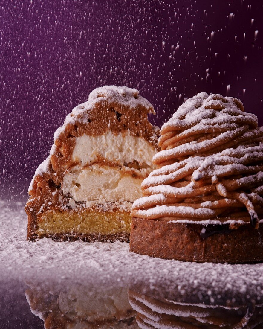 Individual chestnut cream torte with meringue and icing sugar (halved)