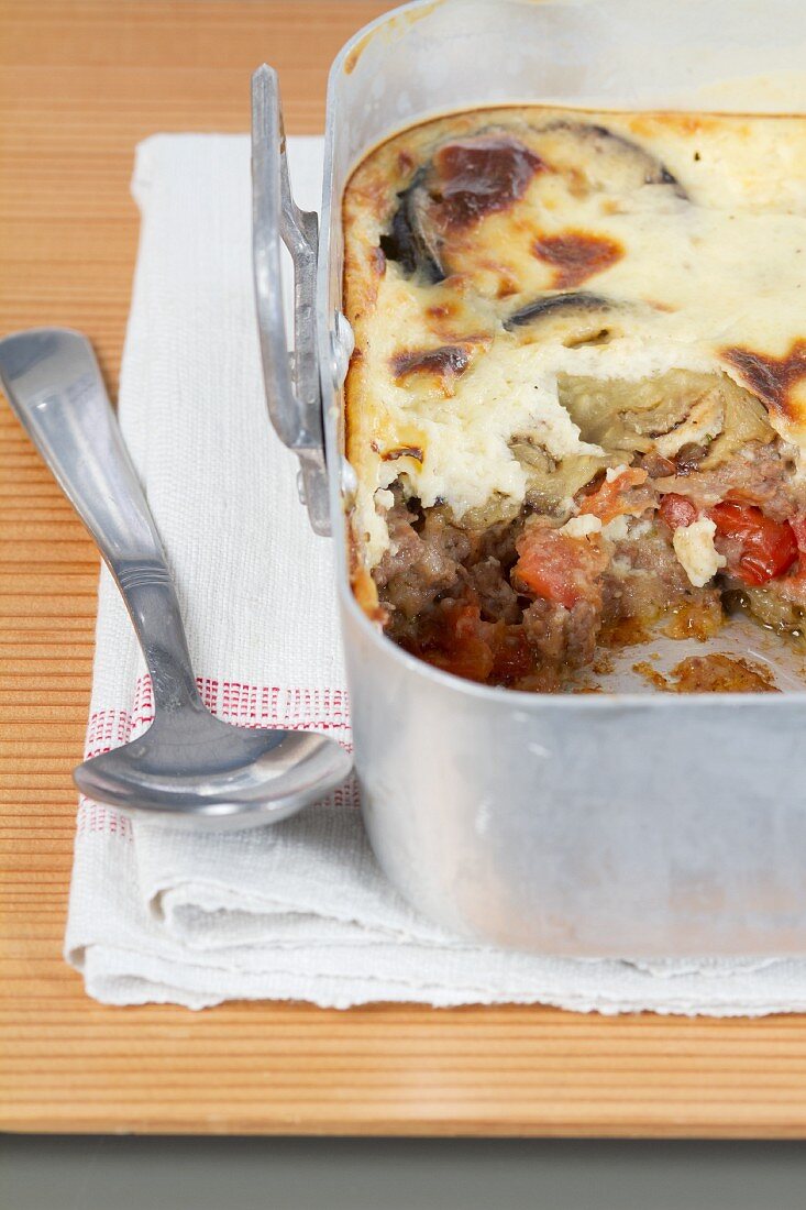 Moussaka in a casserole dish (section)