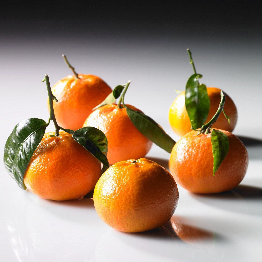 Mandarins with stems and leaves