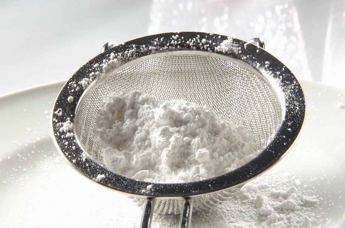 Icing sugar in a sieve