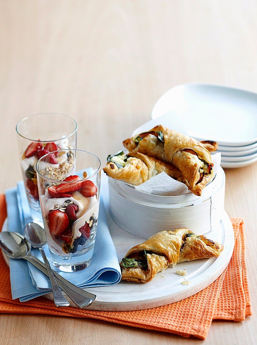 Muesli with berries and yoghurt, served with spinach and ham croissants