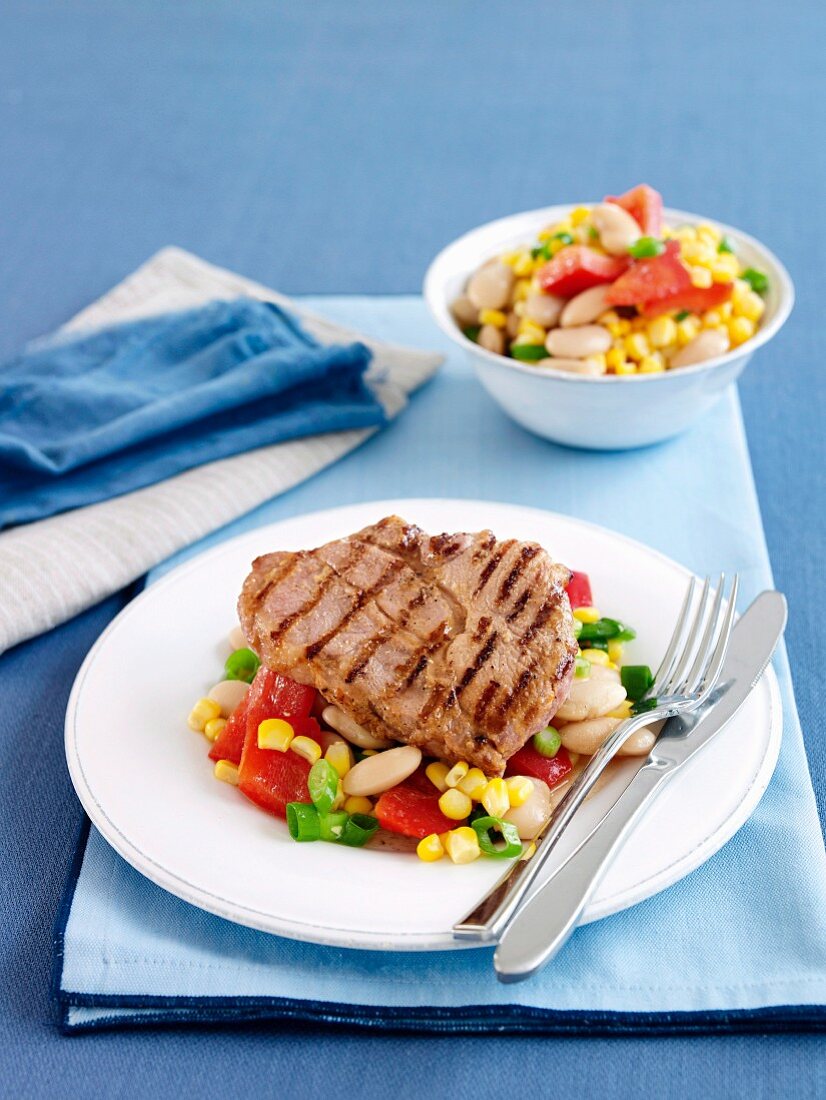 Grilled pork steaks with sweetcorn and vegetable salad