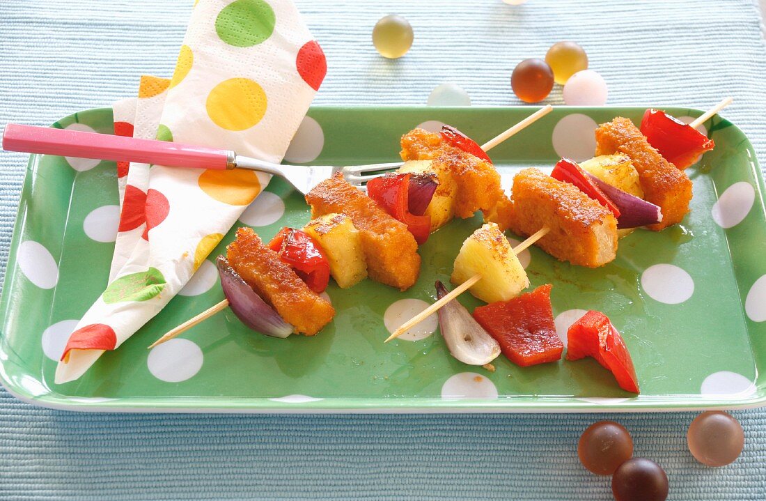 Skewers of fish fingers, pineapple and peppers