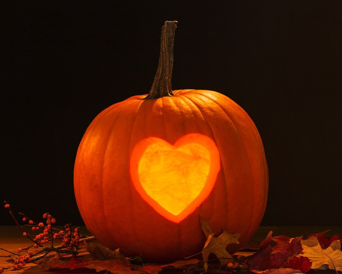 A pumpkin lantern carved with a heart