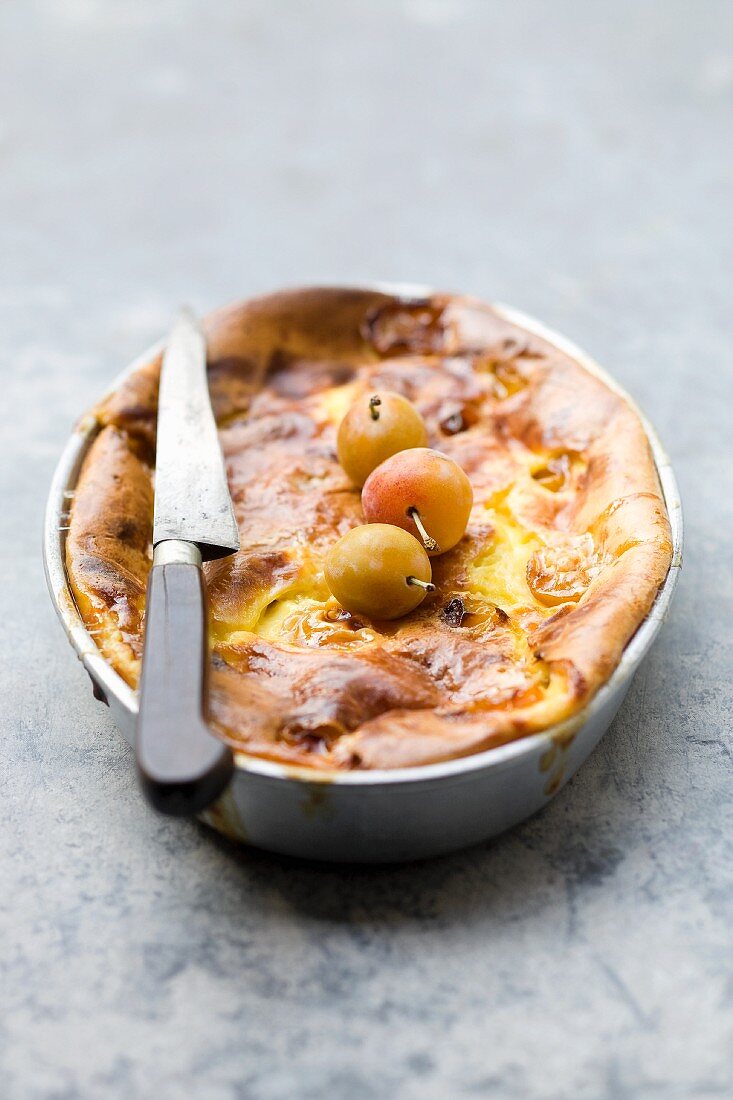 Far Breton with Mirabelle plums in a cake tin