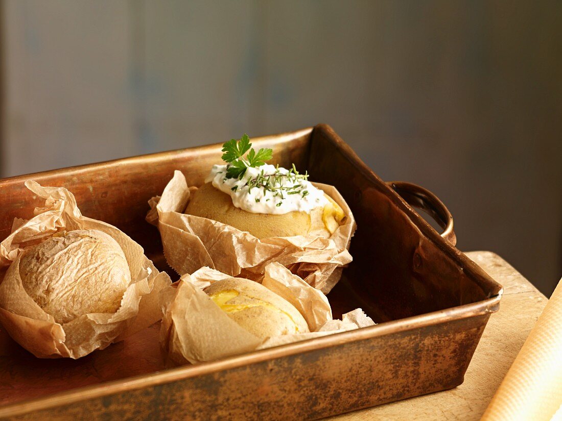 Potatoes baked in paper with a herb dip