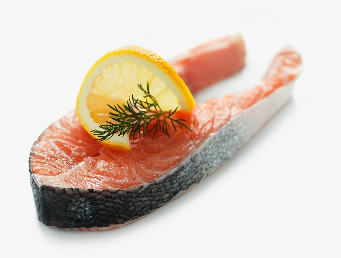 Raw salmon steak with dill and lemon