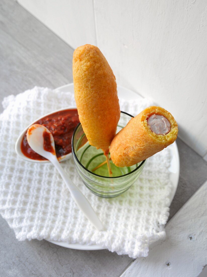 Corn dogs with tomato sauce