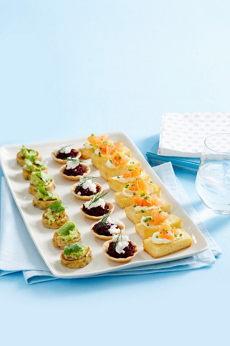 Colourful, savoury finger food; open sandwiches, tarts and mini pancakes