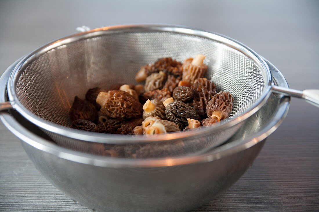 Freshly washed morels in a sieve