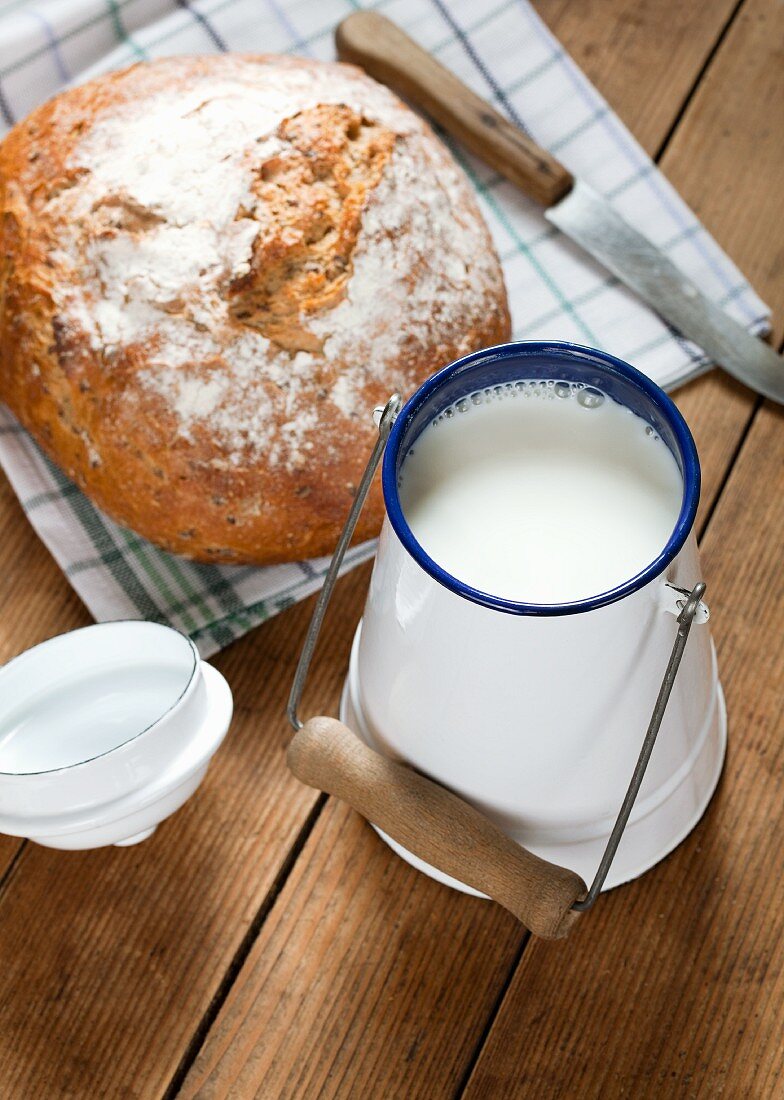 A fresh loaf of bread and a can of milk