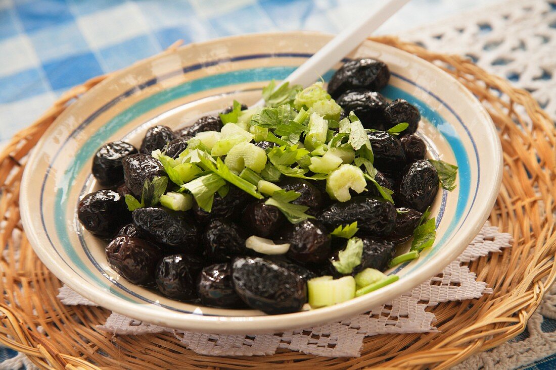 A Bowl of Marinated Black Olive Salad with Celery