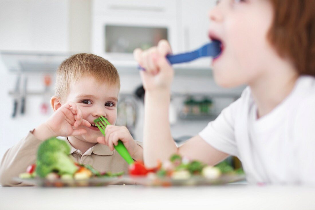 Children eating vegetables together