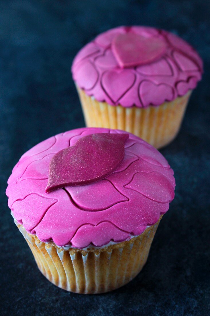 Vanilla cupcakes topped with strawberry fondant icing