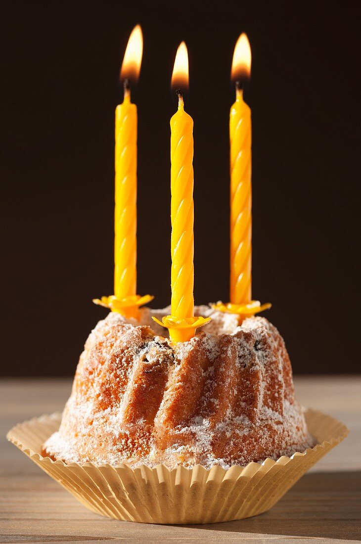 A Bundt cake with lit candles, for a birthday