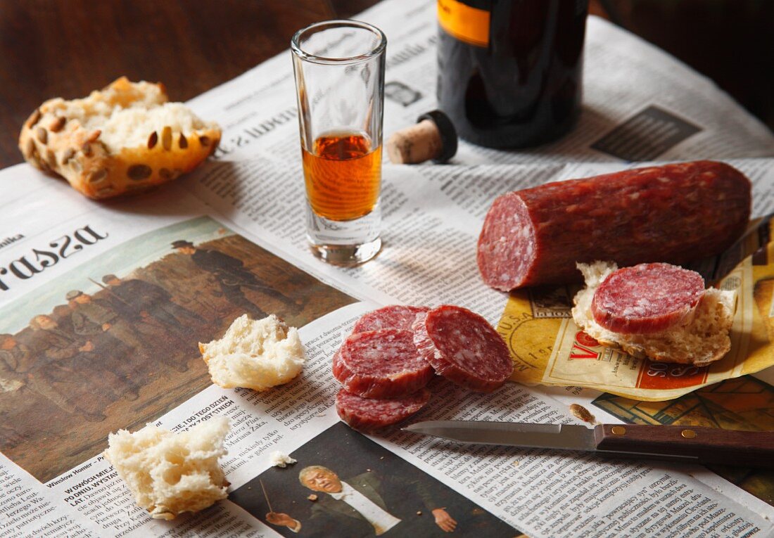 Hard Salami with Bread and a Glass of Sherry on Polish Newspaper