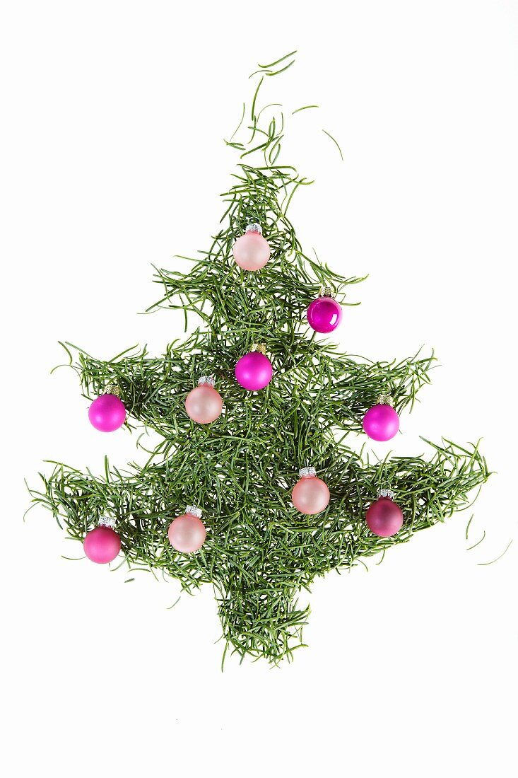 Christmas tree made of pine needles decorated with violet baubles