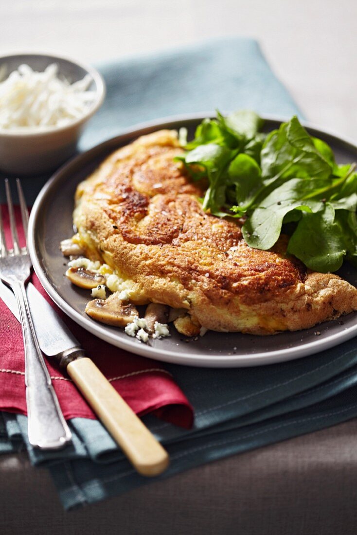 A soufflé omelette with cheese and mushrooms