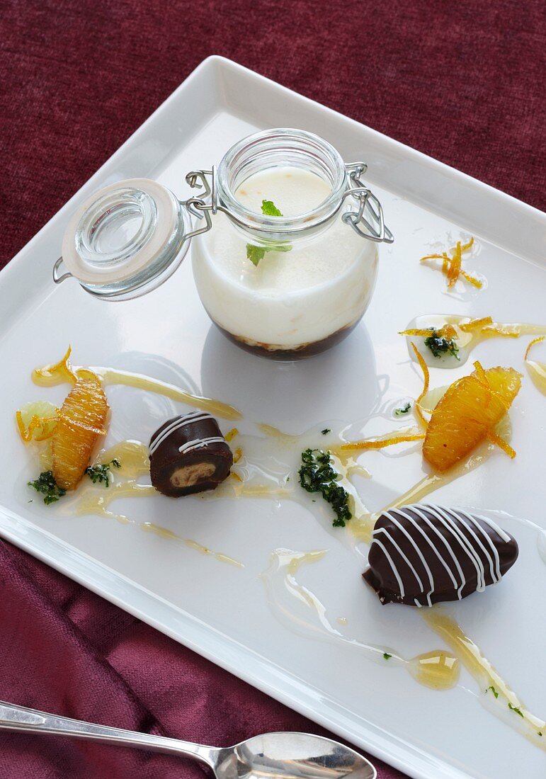 Chocolate-coated banana with orange sauce and yoghurt cream