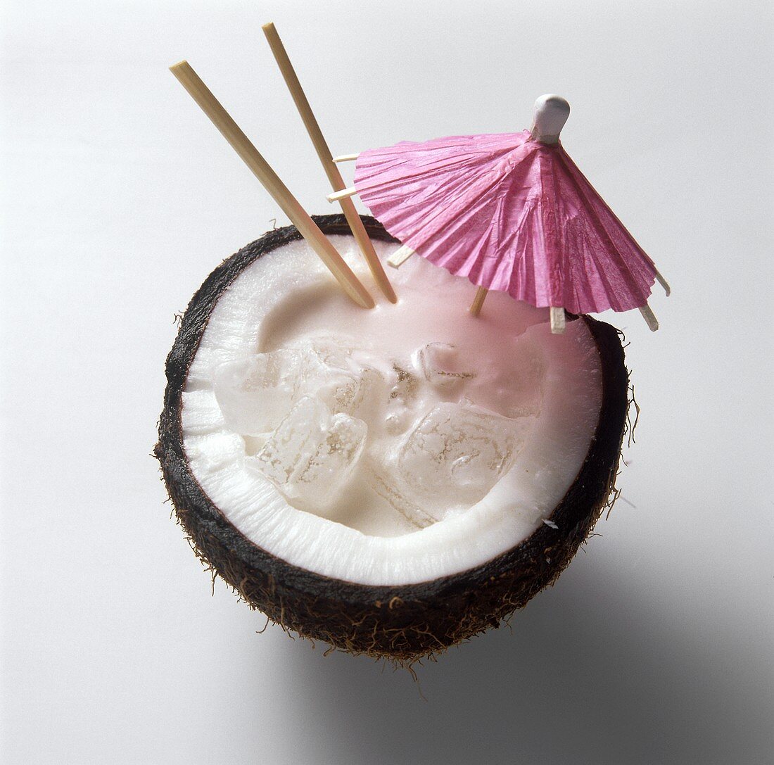 Pina Colada in a Coconut Half with a Cocktail Umbrella