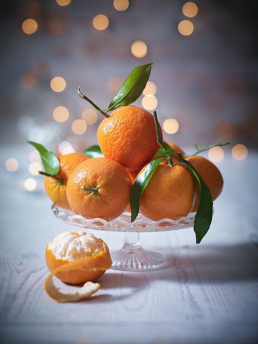 Clementines with leaves in a crystal dish