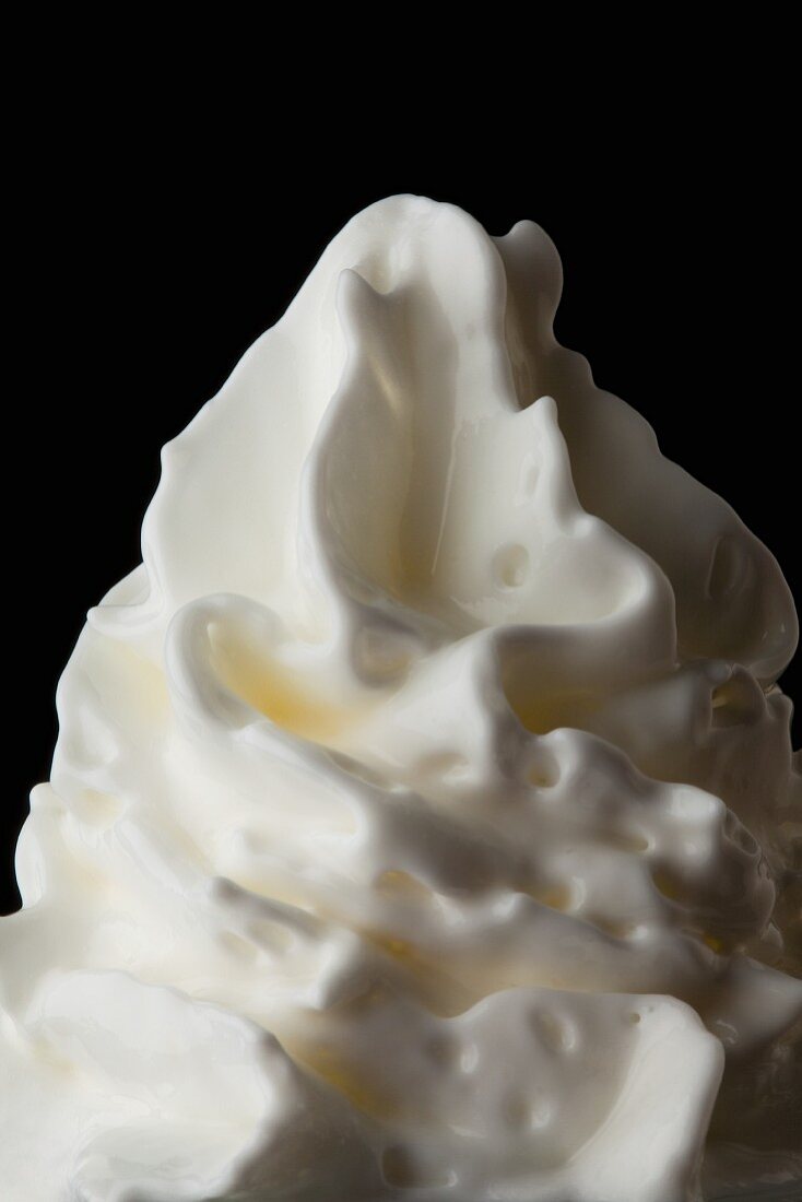 Whipped cream against a black background