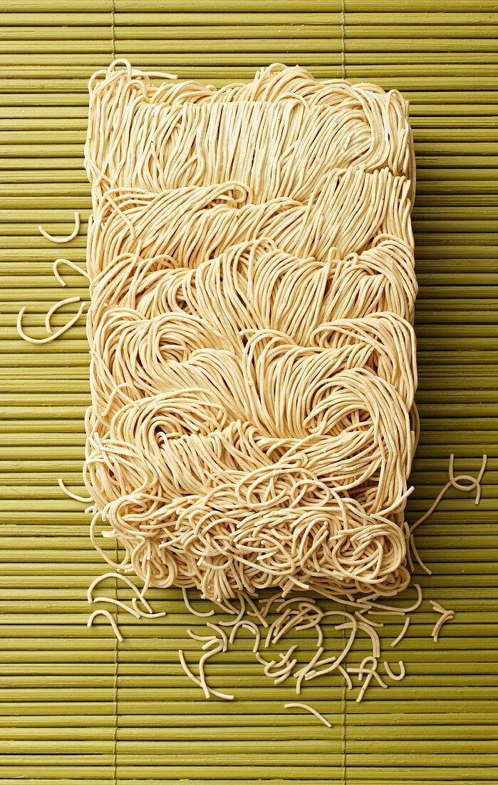 Chinese egg noodles on a bamboo mat