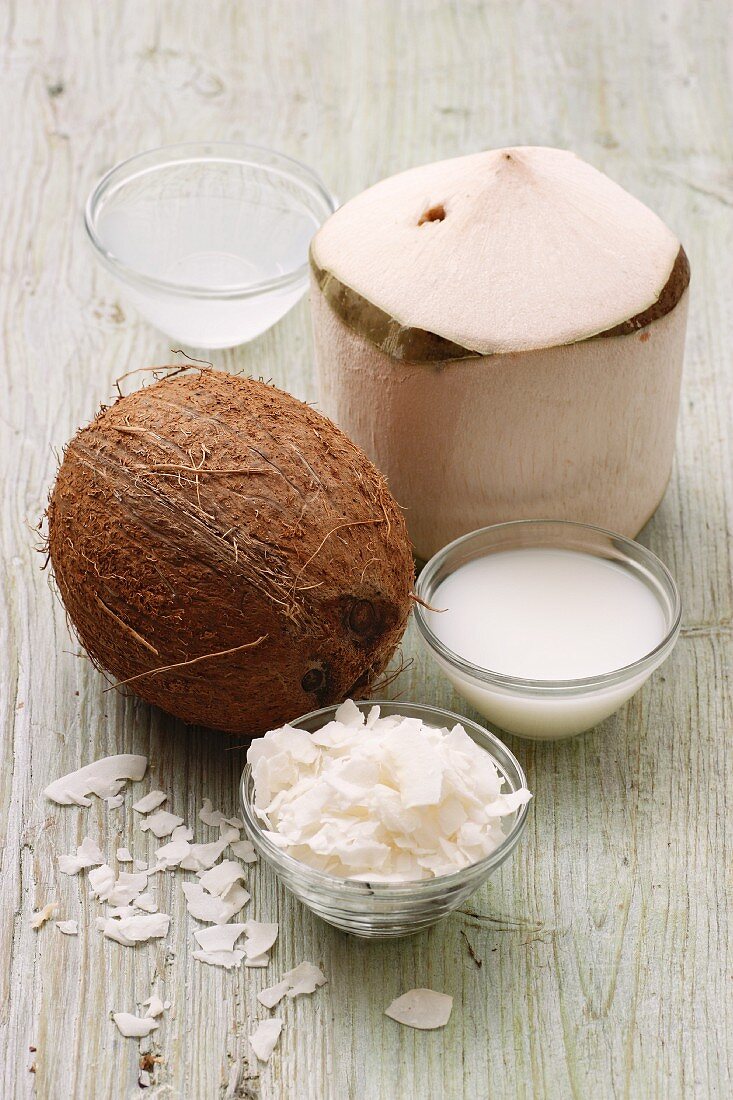 A coconut, coconut water, coconut milk and coconut shavings