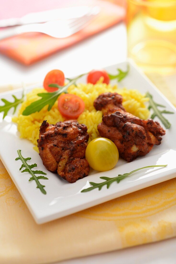 Chicken with saffron rice and cherry tomatoes