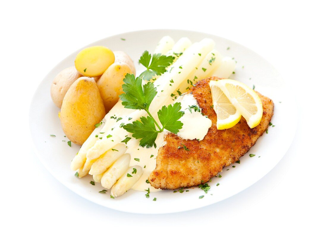 White asparagus and a schnitzel with Hollandaise sauce and potatoes