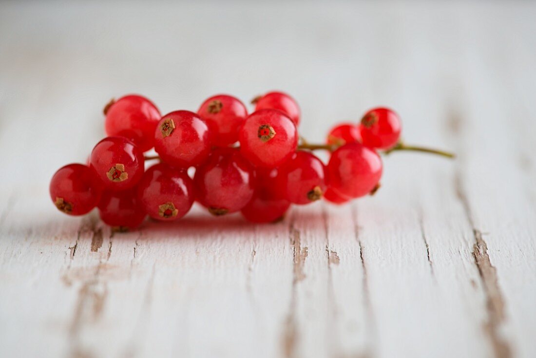 Redcurrants on a weathered wooden surface