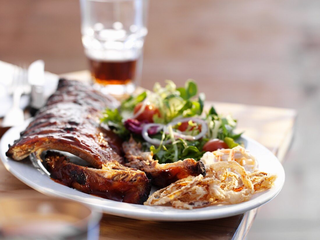 Spareribs mit frittierten Zwiebelringen und Salat