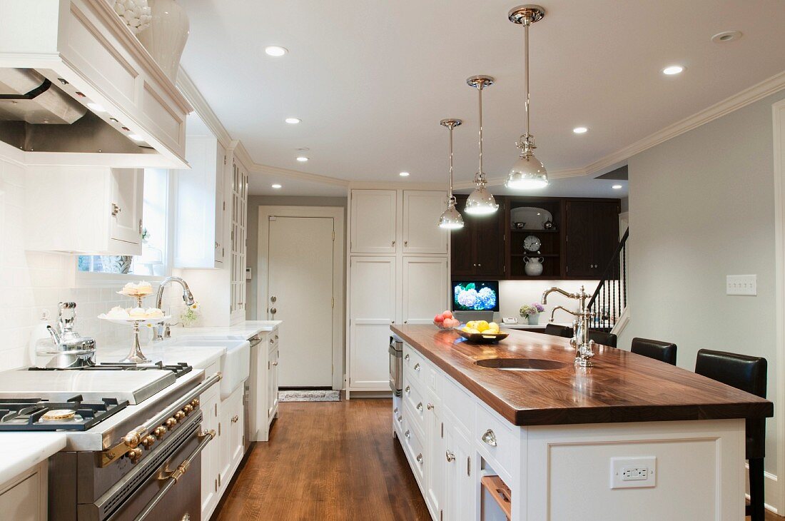 Spacious country-house kitchen with island and walnut worksurface