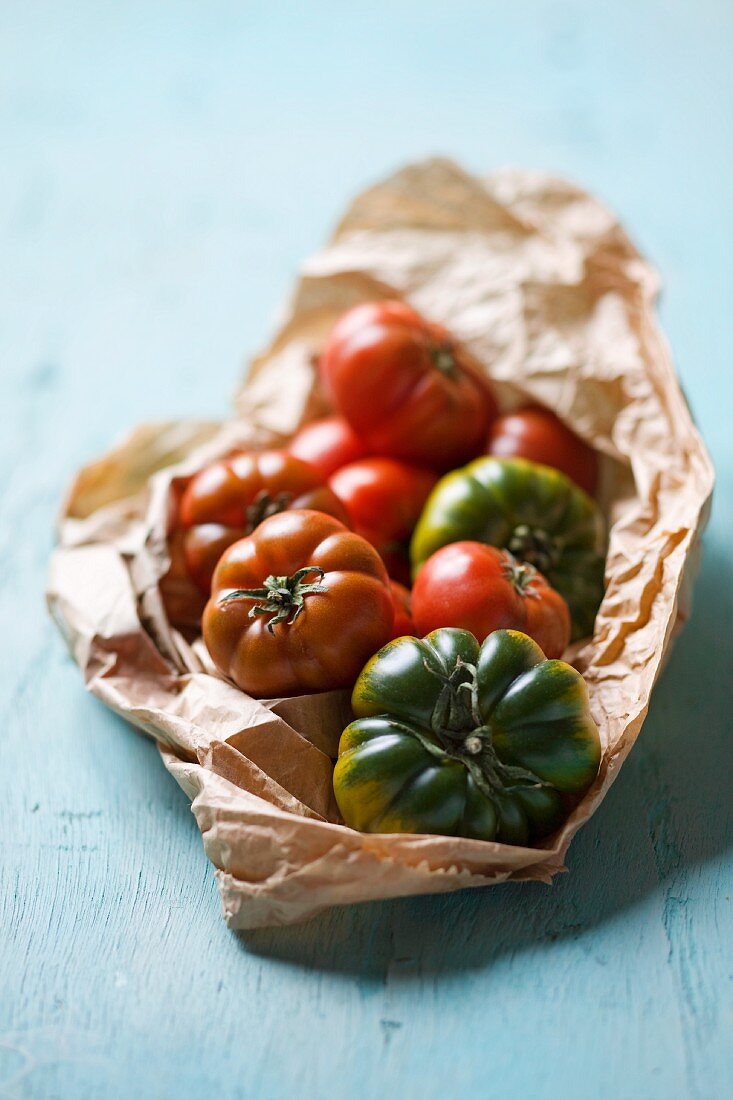 Assorted heirloom tomatoes on crumpled paper