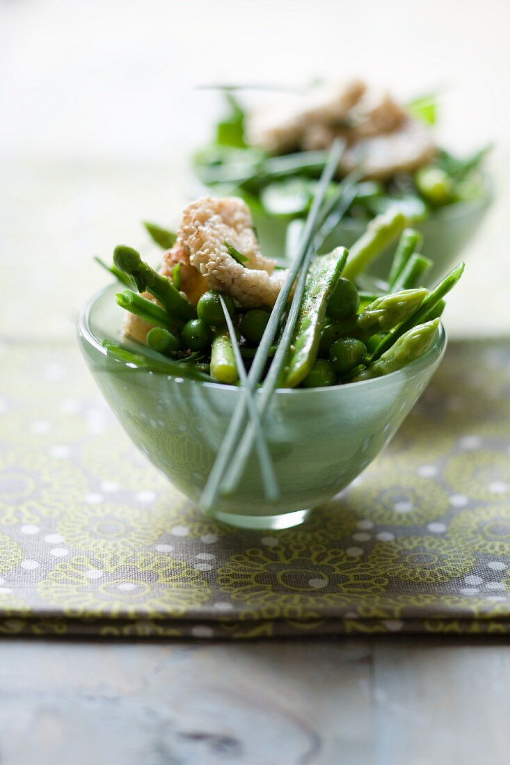 Lukewarm vegetable salad with green beans, peas and asparagus