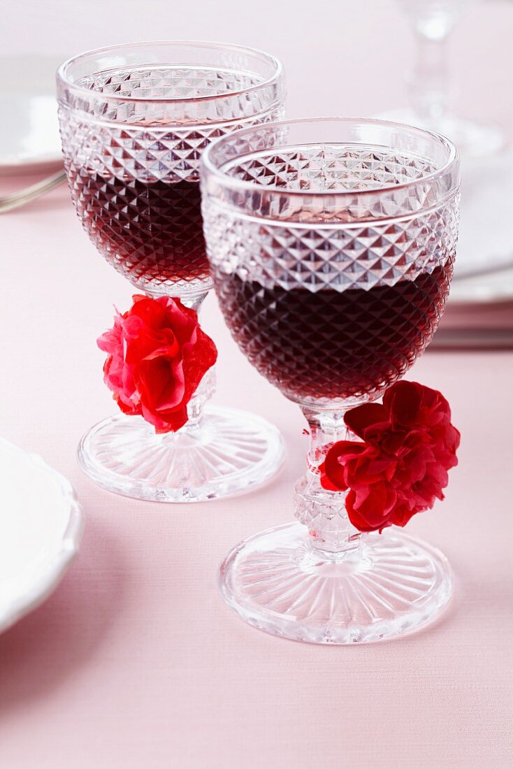 Glasses of red wine decorated with pompoms