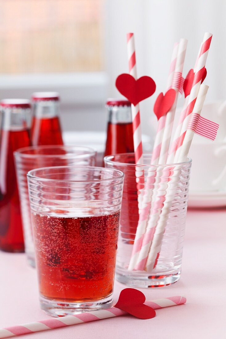 Red lemonade and straws decorated with hearts