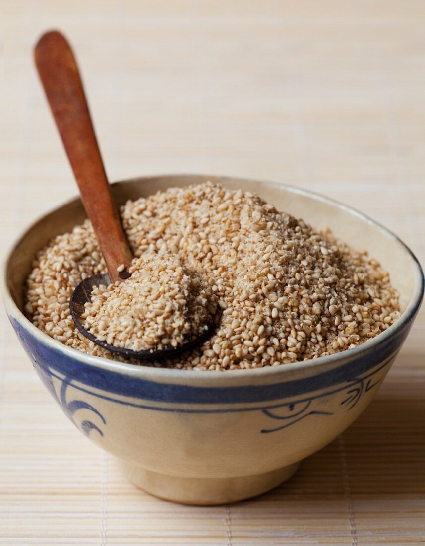 Sesame seeds in a bowl with a spoon