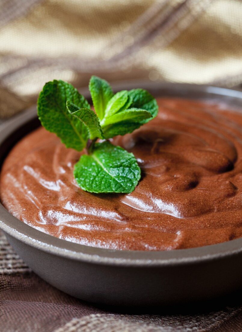 Chocolate mousse with mint leaves