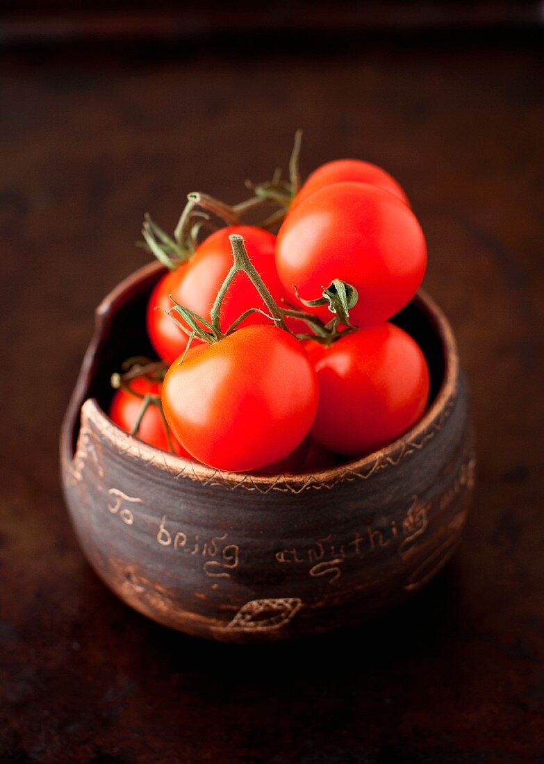 Fresh Cherry Tomatoes in a Small Brown Clay Bowl