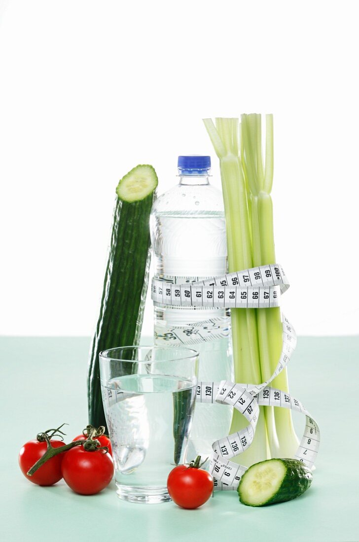 Vegetables and water with a measuring tape